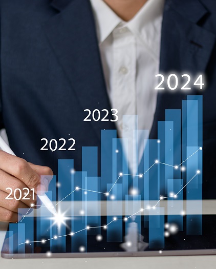 A businessman analyzes a digital growth chart, showing increasing trends from 2021 to 2024 with a stylus on a tablet.